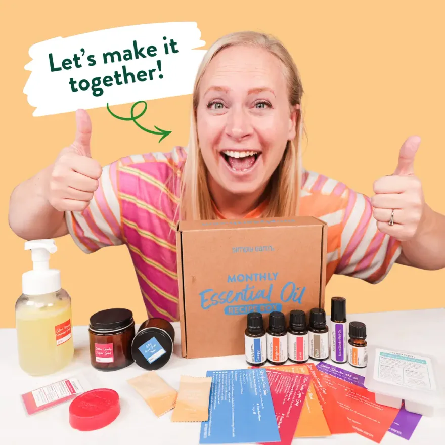 Katie Veldkamp, Simply Earth co-founder, giving two thumbs up behind a Recipe Box, its oils and recipe cards