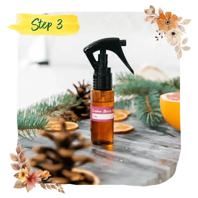 Step 3 — a finished bottle of homemade Cooldown muscle mist among pine and orange slices